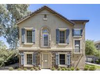 Charming two-story home with stone accents and stylish blue shutters on a sunny day at 5734 S 21St Pl, Phoenix, AZ 85040