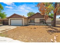 Charming single-story home featuring an attached garage and a low maintenance front yard at 6015 W Acoma Dr, Glendale, AZ 85306