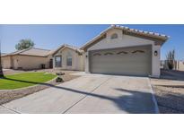 Charming single-story home with a well-manicured lawn, two car garage, and desert landscaping at 6029 E Palm St, Mesa, AZ 85215