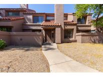Charming townhouse with a red tile roof and a walkway leading to the front door at 609 E Mesquite Cir # D133, Tempe, AZ 85288