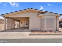 Inviting home exterior with a covered parking and desert landscaping showcasing the charming facade at 6461 S Oakmont Dr, Chandler, AZ 85249