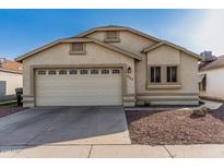 Charming single-story home featuring a two-car garage and a well-maintained stucco exterior and desert landscaping at 8566 N 108Th Ln, Peoria, AZ 85345
