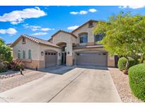 Charming two-story home with a three-car garage, desert landscaping, and a well-maintained front yard at 1124 E Jahns Dr, Casa Grande, AZ 85122
