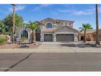Stunning two-story home with a three-car garage and desert landscaping at 11257 E Reginald Ave, Mesa, AZ 85212