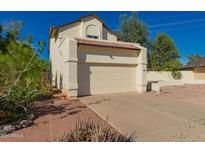 Two-story home featuring a two-car garage, red tile roof, and low-maintenance desert landscaping at 1621 N Chippewa Dr, Chandler, AZ 85224