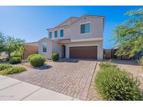 Charming two-story home boasts a well-maintained brick driveway and desert landscaping at 1744 W Hopi Dr, Coolidge, AZ 85128