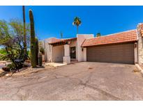 Southwest style home with a brown tile roof, stucco walls, desert landscaping, and a two car garage at 1831 N 77Th St, Scottsdale, AZ 85257