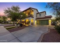Charming home featuring a 2-car garage, balcony, and a well-manicured lawn at 20518 W White Rock Rd, Buckeye, AZ 85396