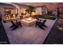 Inviting backyard featuring a fire pit and lounge seating, perfect for outdoor entertaining at 22837 E Orchard Ln, Queen Creek, AZ 85142
