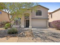 Inviting two-story home featuring a two-car garage and low maintenance desert landscaping at 2511 W Blue Sky Dr, Phoenix, AZ 85085