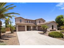 Inviting two-story home showcasing a three-car garage and well-manicured landscaping, enhancing its curb appeal at 2614 E Carob Dr, Gilbert, AZ 85298