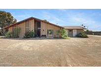 Charming brick home featuring a peaked roof, desert landscaping, and welcoming front entrance at 2921 N 103Rd Ave, Avondale, AZ 85392
