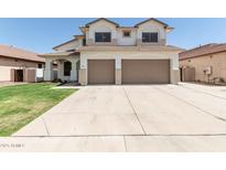 Two-story home features a two-car garage, green lawn, and desert landscaping at 3851 E San Pedro Ave, Gilbert, AZ 85234