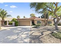 Charming single-story home featuring desert landscaping and a tile roof at 5450 E Paradise Ln, Scottsdale, AZ 85254