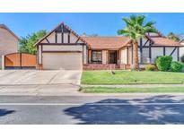Charming single-Gathering home with a well-manicured lawn, brick accents, and a two-car garage at 6708 W Utopia Rd, Glendale, AZ 85308