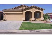 Inviting single-story home featuring a low-maintenance yard, two-car garage, and desert landscaping at 674 E Renegade Pl, San Tan Valley, AZ 85143