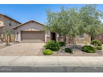 Charming single-story home with a well-manicured front yard and a two-car garage, great curb appeal at 699 S 197Th Dr, Buckeye, AZ 85326
