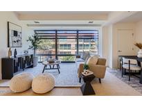 Bright living room with large window, modern furnishings, and neutral color palette at 7151 E Rancho Vista Dr # 6002, Scottsdale, AZ 85251