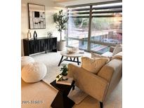 Modern living room featuring a neutral palette, stylish furniture, and large windows offering bright natural light at 7151 E Rancho Vista Dr # 6002, Scottsdale, AZ 85251
