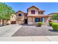 Charming two-story home with a spacious driveway, beautiful landscaping, and a welcoming facade at 742 E Kingbird Dr, Gilbert, AZ 85297