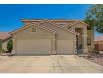 Charming two-story home with a three car garage and desert landscaping at 7923 W Hess Ave, Phoenix, AZ 85043