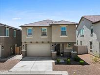 Charming two-story home with a two-car garage, neutral stucco, and well-kept landscaping at 880 S 150Th Dr, Goodyear, AZ 85338