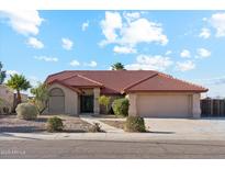 Charming single-story home featuring a well-manicured front yard and a classic red tile roof at 1192 E Sunset Dr, Casa Grande, AZ 85122
