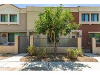 Charming townhouse with a cozy front yard and secure wrought iron fence at 125 N Sunvalley Blvd # 119, Mesa, AZ 85207