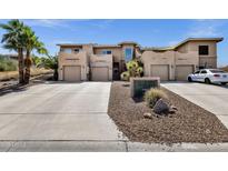 Beautiful exterior view of a modern home with private garages and desert landscaping at 12852 N Mountainside Dr # 2, Fountain Hills, AZ 85268