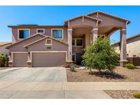 Inviting two-story home featuring desert landscaping, a two-car garage, and an arched entryway at 15792 W Desert Mirage Dr, Surprise, AZ 85379