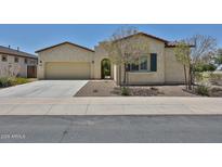 Charming single-story home with a two-car garage, desert landscaping, and an inviting front entrance at 17082 S 182Nd Ave, Goodyear, AZ 85338