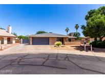 Charming single story home with brick facade, desert landscaping and a two car garage at 1804 S Standage Cir, Mesa, AZ 85202