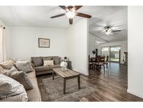 Inviting living room with a comfortable brown sofa, area rug, and open access to the dining area at 18818 N 12Th Ave, Phoenix, AZ 85027