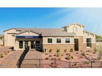 A charming single-Gathering house featuring a stone facade, desert landscaping, and a well-manicured front yard at 19910 W Mulberry Dr, Buckeye, AZ 85396