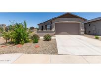 Charming single-story home with a well-manicured lawn and inviting two-car garage at 23112 E Twilight Dr, Queen Creek, AZ 85142