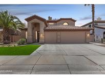 Inviting two-story home with a three-car garage and well manicured lawn at 2461 E Stephens Pl, Chandler, AZ 85225