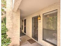 Exterior shot of an apartment entrance featuring a security door and a window with blinds at 3119 W Cochise Dr # 148, Phoenix, AZ 85051