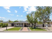 Charming single-story home with manicured lawn, brick pathway, and inviting curb appeal at 3201 E Colter St, Phoenix, AZ 85018