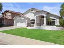 Charming single-story home features stucco siding, manicured lawn and covered front porch at 4566 E La Costa Dr, Chandler, AZ 85249