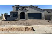 Charming two-story home with a well-manicured front yard and a two-car garage at 713 W Longwood Dr, Queen Creek, AZ 85140