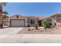 Charming single-story home featuring desert landscaping, a neutral color palette, and a two-car garage at 7205 W Ellis St, Laveen, AZ 85339