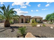 Stunning single-Gathering home with stone accents, desert landscaping, and a well-manicured front yard at 7205 W Fallen Leaf Ln, Peoria, AZ 85383