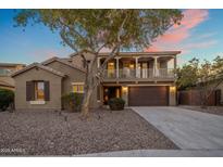 Two-story home featuring a two-car garage, low-maintenance landscaping, and a second-story balcony at 7616 S Sorrell Ln, Gilbert, AZ 85298