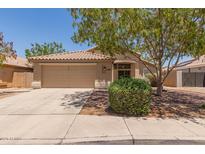 Charming single-story home featuring a tile roof, well-manicured landscaping, and a two-car garage at 10318 E Plata Ave, Mesa, AZ 85212
