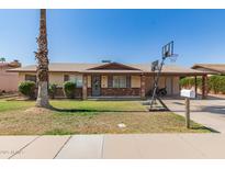 Charming single-story home with brick accents, desert landscaping, and a driveway with basketball hoop at 1263 W Del Rio St, Chandler, AZ 85224