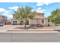 Charming two-story home featuring a well-manicured yard, neutral color palette, and a convenient two-car garage at 14161 W Poinsettia Dr, Surprise, AZ 85379