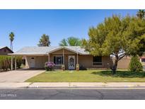 Charming single-story brick home with a covered entrance and lush green lawn at 1454 W Capri Ave, Mesa, AZ 85202