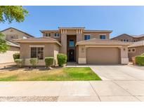 Charming two-story home featuring a well-manicured lawn and a two-car garage at 17419 W Elaine Dr, Goodyear, AZ 85338