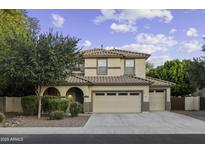 Inviting two-story home featuring a tile roof, multiple car garage, and well-maintained landscaping at 1953 E Lafayette Ave, Gilbert, AZ 85298