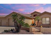 Inviting single-story home boasting desert landscaping, walkway, and warm exterior lighting at 2069 E Winchester Way, Chandler, AZ 85286